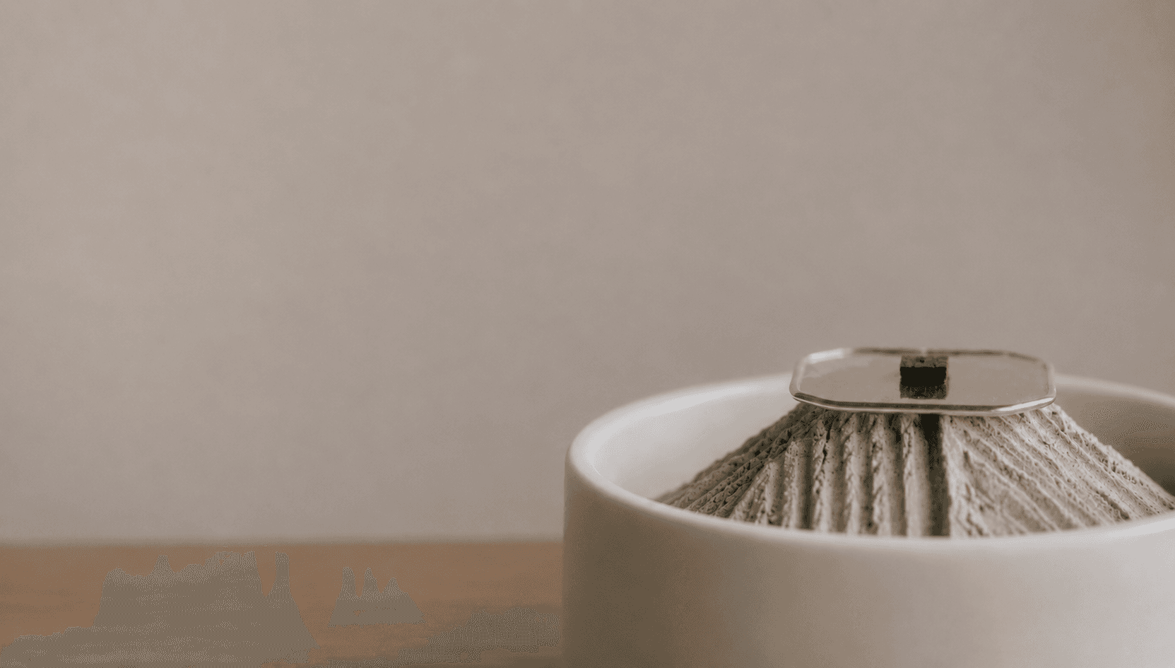 Atmospheric incense smoke drifting through soft light